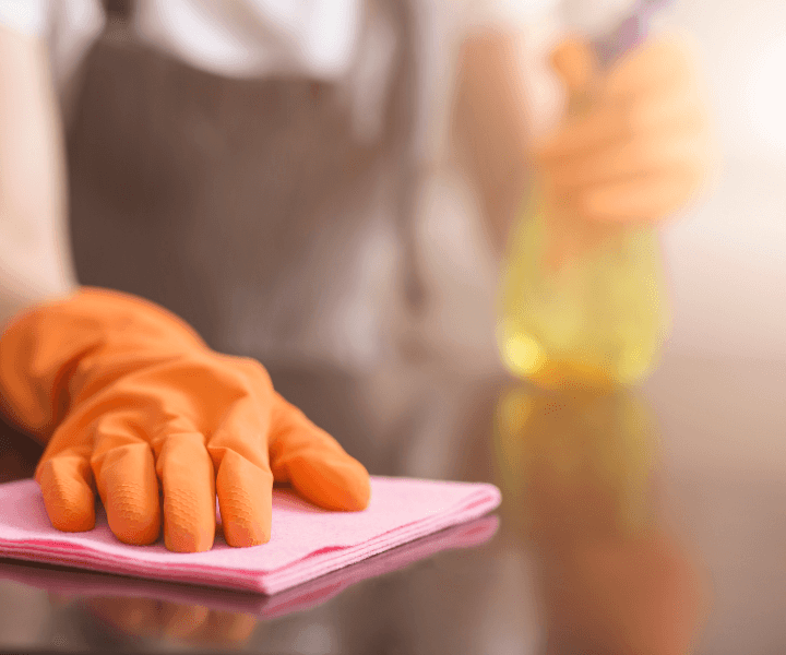 Cleaner wiping a table during a detailed deep cleaning service